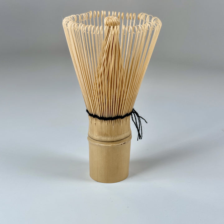 Close-up of bamboo matcha whisk tool on a clean background for tea preparation