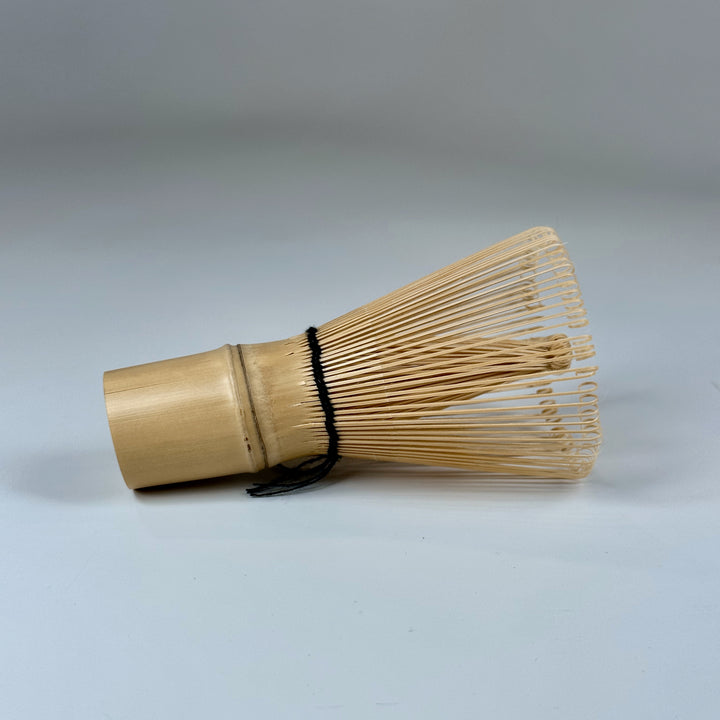 Traditional bamboo chasen with fine prongs for preparing smooth, foamy matcha.