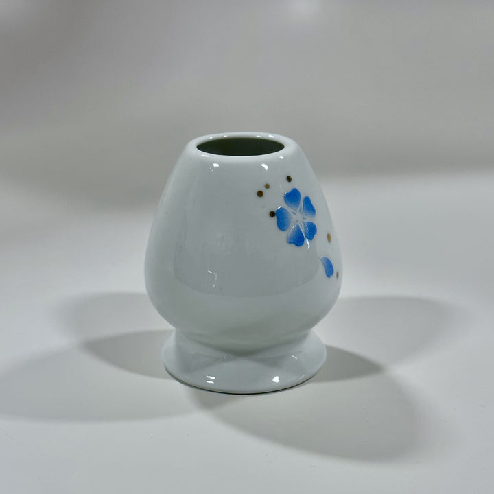Decorative blue floral kusenaoshi for preserving matcha whisk shape.