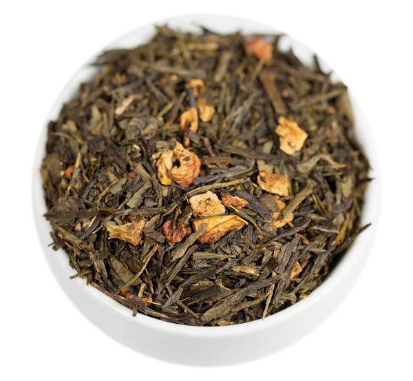 A close-up image of washington apple loose leaf green tea leaves with pieces of dried apple mixed in.