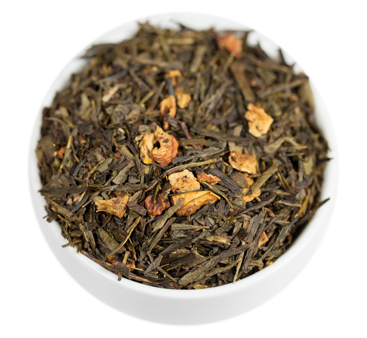 A close-up image of washington apple loose leaf green tea leaves with pieces of dried apple mixed in.